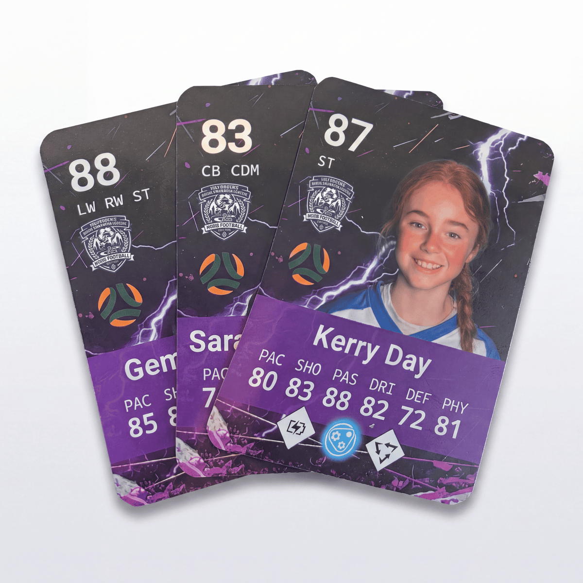 Three custom sports trading cards fanned out on a light gray background. The cards feature a dark purple and black design with purple lightning accents, player statistics, team crests, and a photo of a young girl.